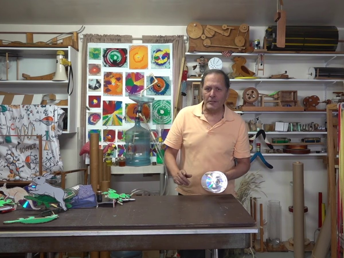 Bruce Yeany in his workshop, surrounded by shelves of homemade science gadgets